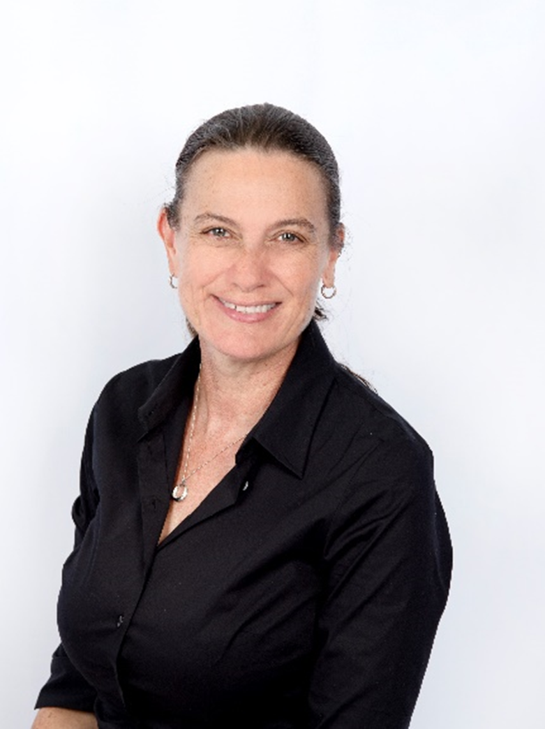 Headshot of Ruth Wallace - smiling woman with dark hair in a pony tail, silver necklace and earrings and a black buttoned business jacket.