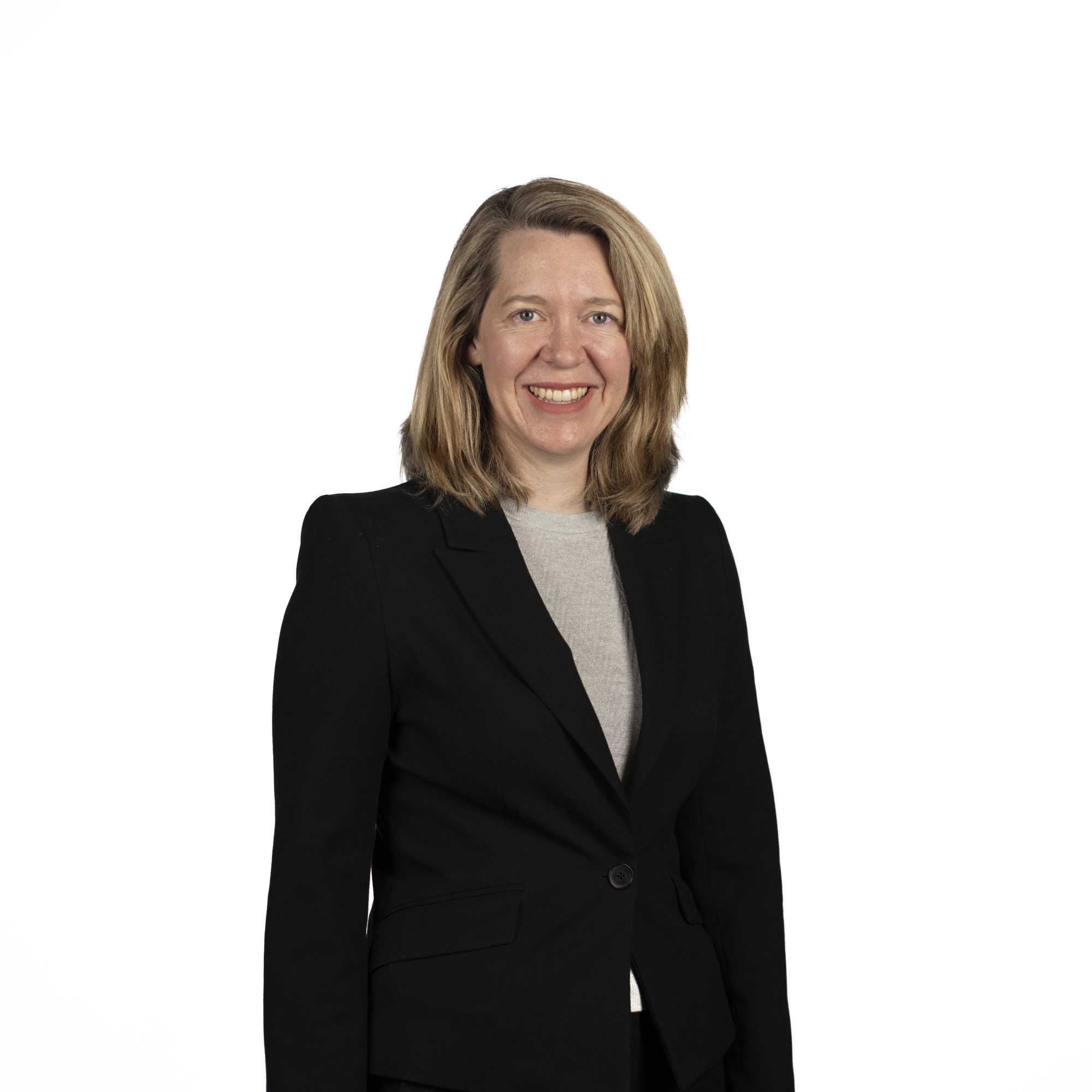 Sophie Horgan headshot - image of a woman smiling with shoulder length blonde hair wearing a beige top and a black blazer.